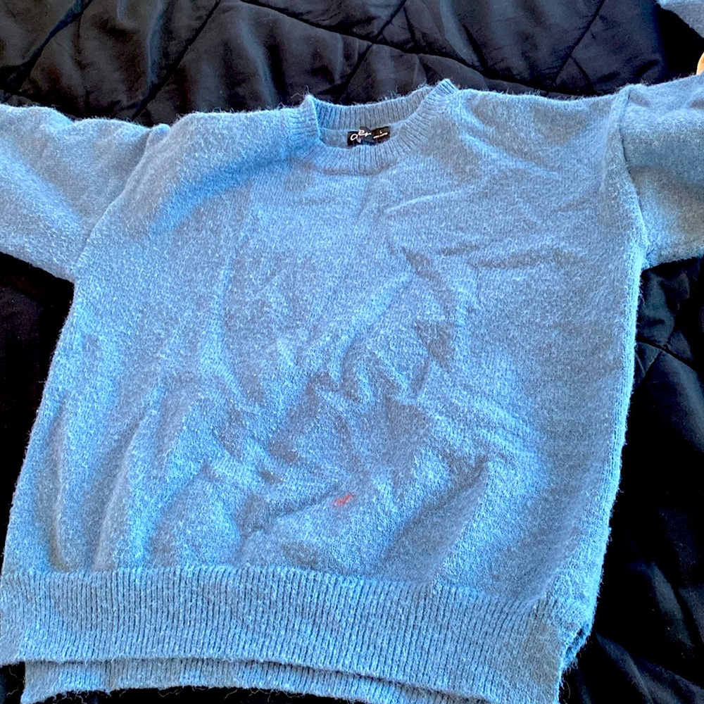 its a blue sweater a small red paint stain on the front though